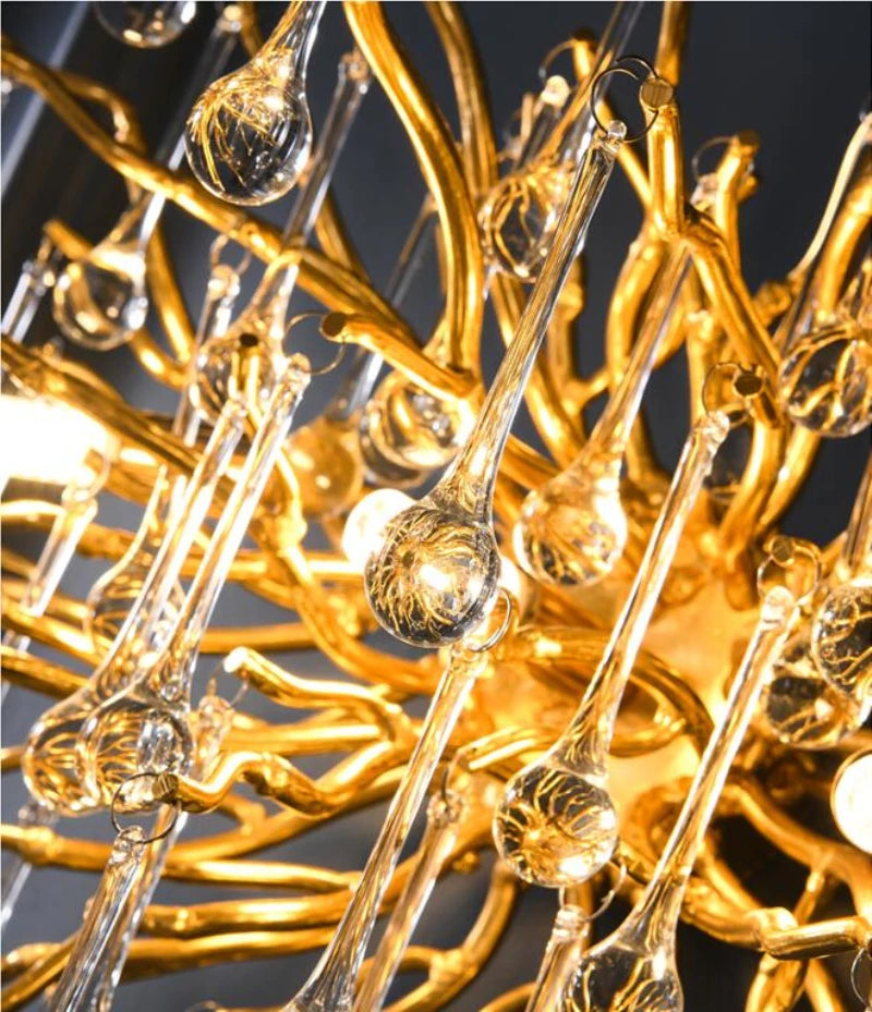 DRIBBLE (WALL) close-up of gold-finish branches with clear crystal drops, lit