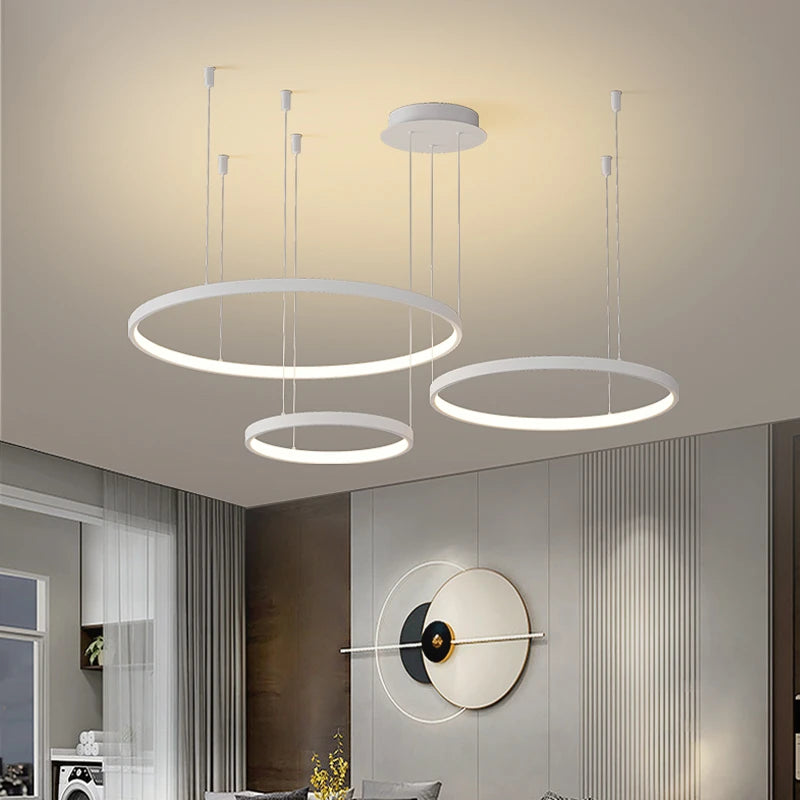 CIRCLETS three white LED rings on a white canopy, lit, in a living room