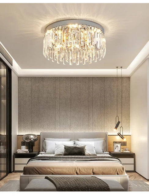 AMELIA round crystal ceiling light, lit, above a bed in a neutral bedroom