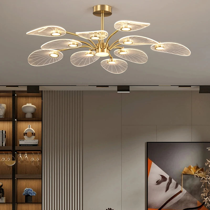 ORVIAN ceiling light with clear petal shades on gold-finish arms, lit, in a living room