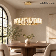 CEREN chandelier above a round walnut dining table with upholstered chairs