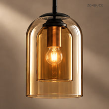 Close-up of MAELLE nested amber glass shades and warm illuminated bulb