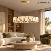 CEREN chandelier in a warm living room with ivory sofa and oval stone coffee table