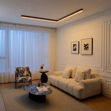 Dark walnut-effect LUNIVA linear light isolated against a pale background.