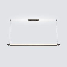 Black NOXVARE linear light centered over a stone kitchen island with dark cabinetry.