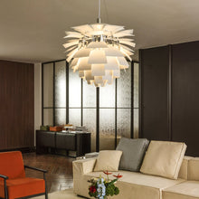 White SYLUNE chandelier isolated with a softly illuminated layered metal form.