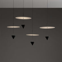 CONIA - Multiple white disc and black cone pendants at staggered heights