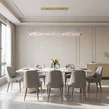 SEVRAYA suspended crystal bar above a white dining table beside tall windows
