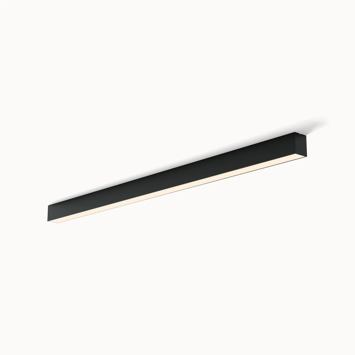 Two parallel black LUNIVA lights mounted over a bright sitting area.