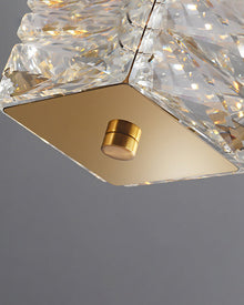 Macro view of SEVRAYA gold square end plate and cylindrical bolt beside faceted crystal
