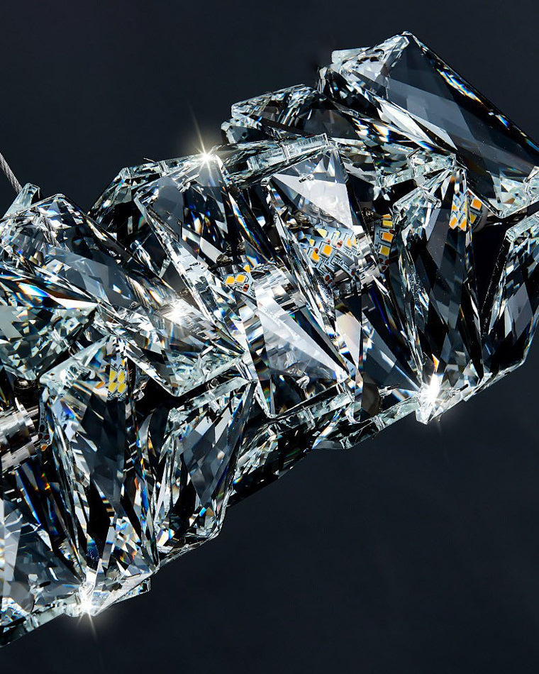 SEVRAYA sharply faceted clear crystal blocks photographed against a dark background