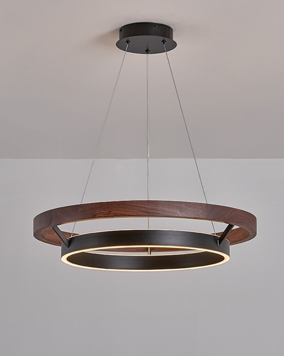 Angled installed view of ORLUNEA’s walnut outer ring and offset black inner ring.
