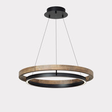 Warm ORLUNEA chandelier centered over a neutral sofa and coffee table.