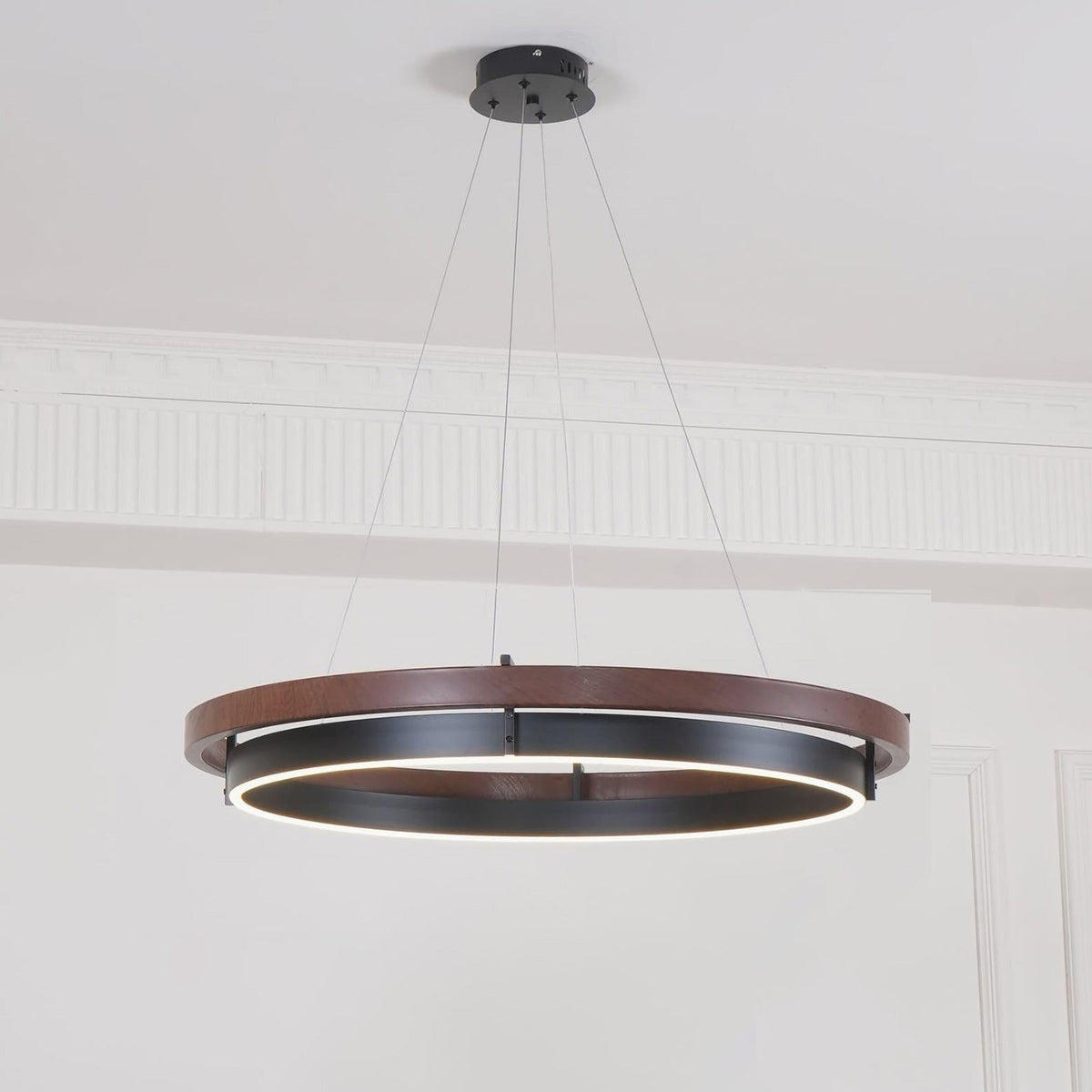 ORLUNEA wood ring chandelier suspended above a round dining table in a sunlit room.
