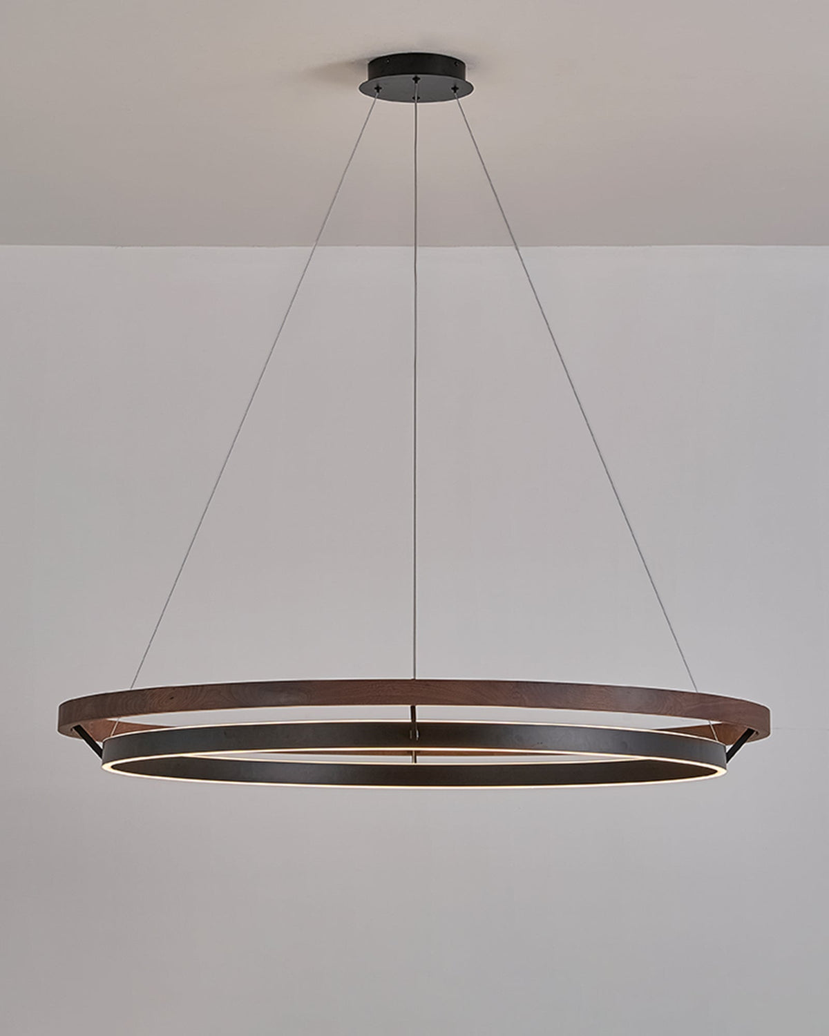 Walnut ORLUNEA chandelier isolated, showing the offset black illuminated ring below.