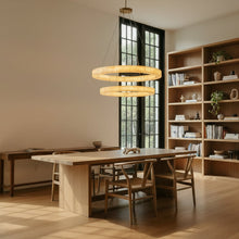 Dining room with wooden table and chairs, large bookshelf, and large windows.