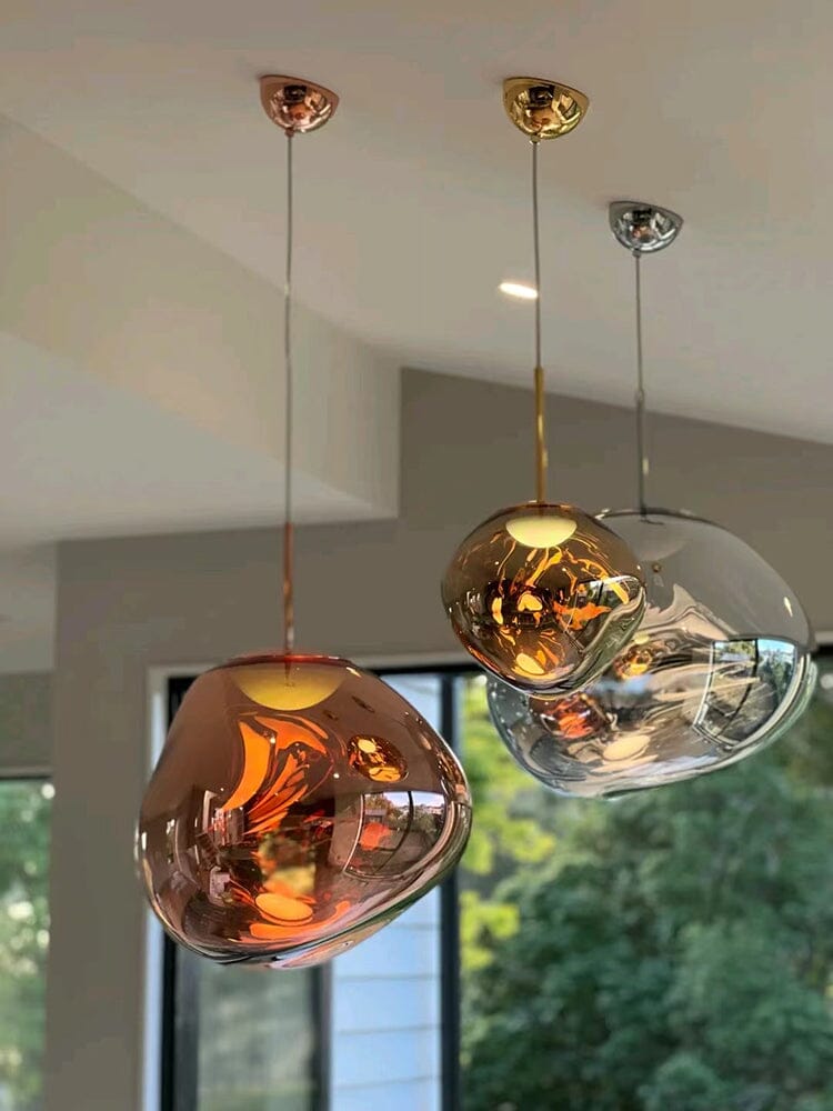 LAVA rose gold, gold and smoke-clear pendants hung at three heights by a window