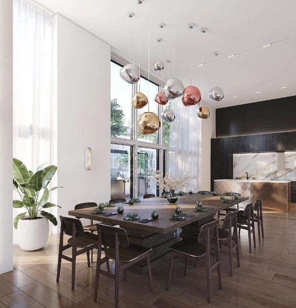 LAVA mixed silver, gold and rose gold pendants above a long table in a tall-windowed restaurant