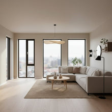 Modern living room with a gray sectional sofa, wooden coffee table, and decorative pillows.