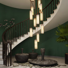 Staircase with modern pendant lights and decorative elements in a home setting