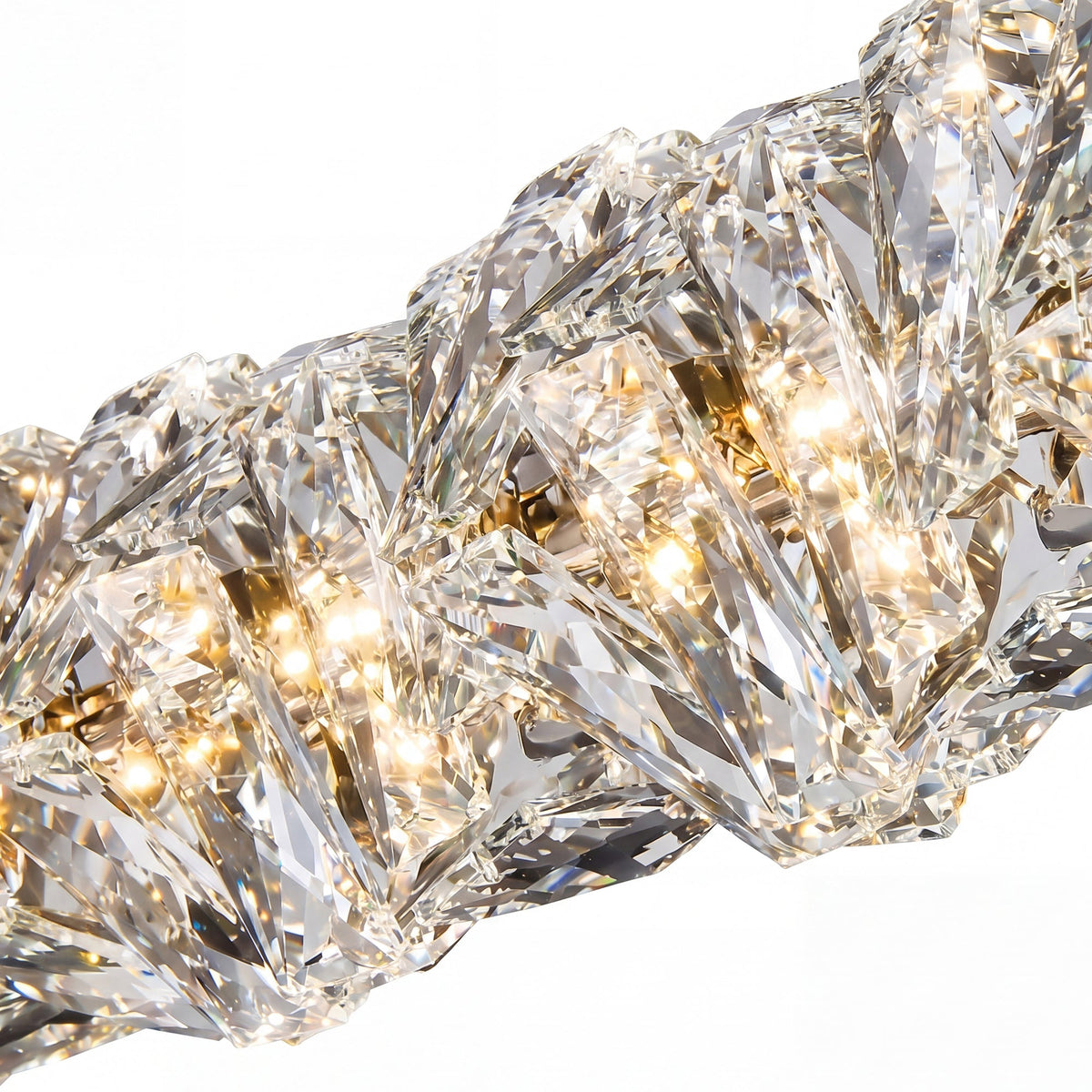 Close-up of SEVRAYA clear angular crystal facets refracting warm light