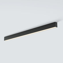 Two slim LUNIVA ceiling bars lighting a bright neutral living room.