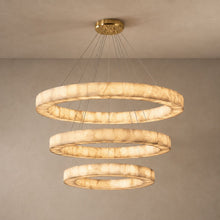AINA three-tier alabaster ring chandelier on a mushroom taupe background with natural canopy shadows