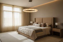 Modern pendant light fixture in a room with a wooden cabinet and decorative items.