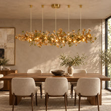 ALUNA Linear Coffee ginkgo glass chandelier above a walnut dining table
