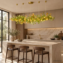 ALUNA Linear Green ginkgo glass chandelier above a limestone kitchen island