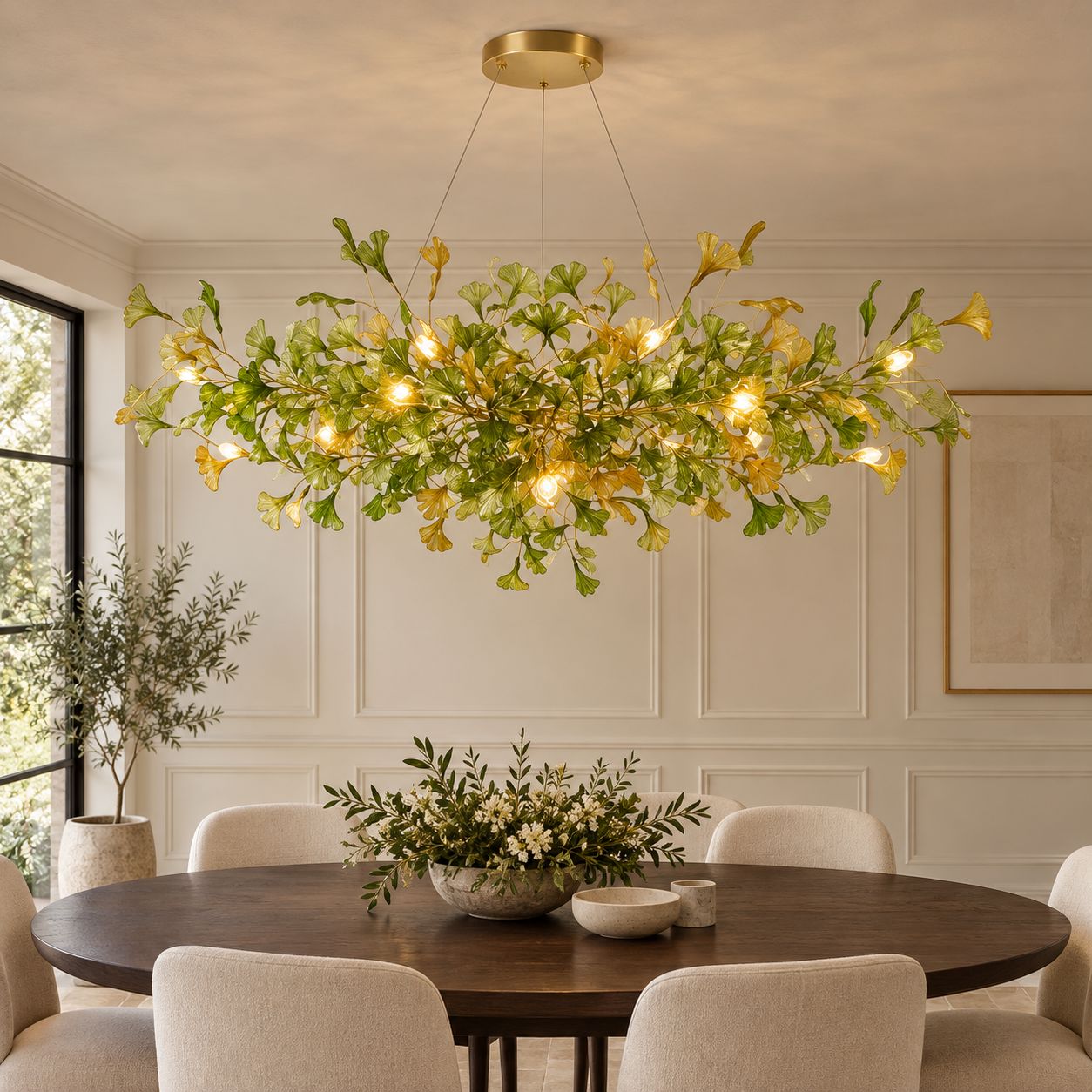 ALUNA Round Green ginkgo glass chandelier above an oval dining table