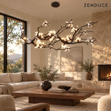 ALVIA branch chandelier visualization in a living room with a stone fireplace and linen sofa