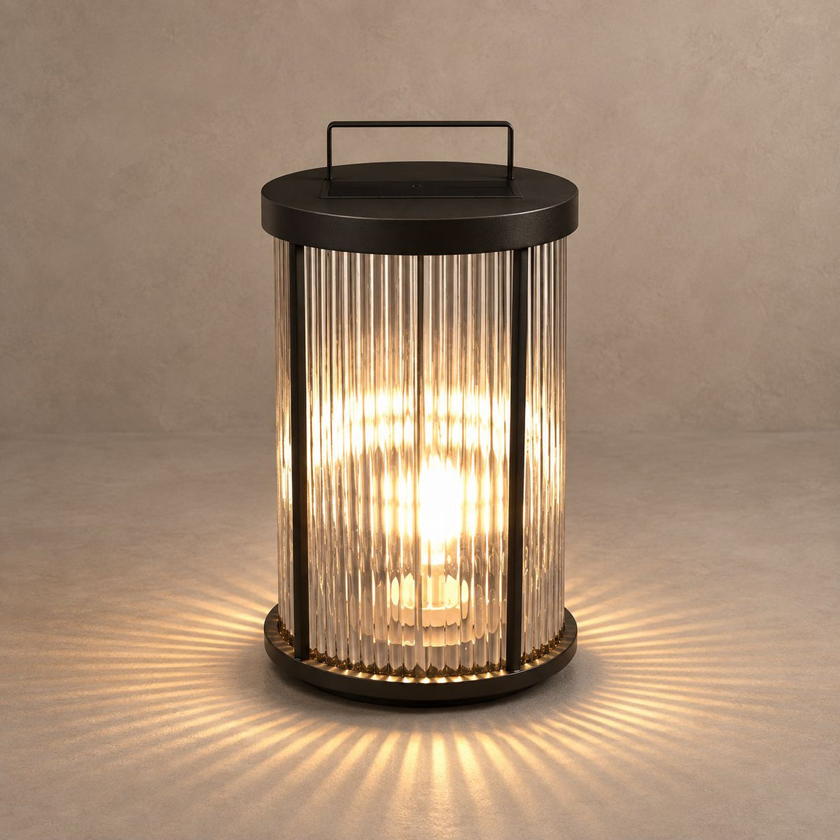 ARDI black lantern with fluted glass on a mushroom taupe surface with natural shadows