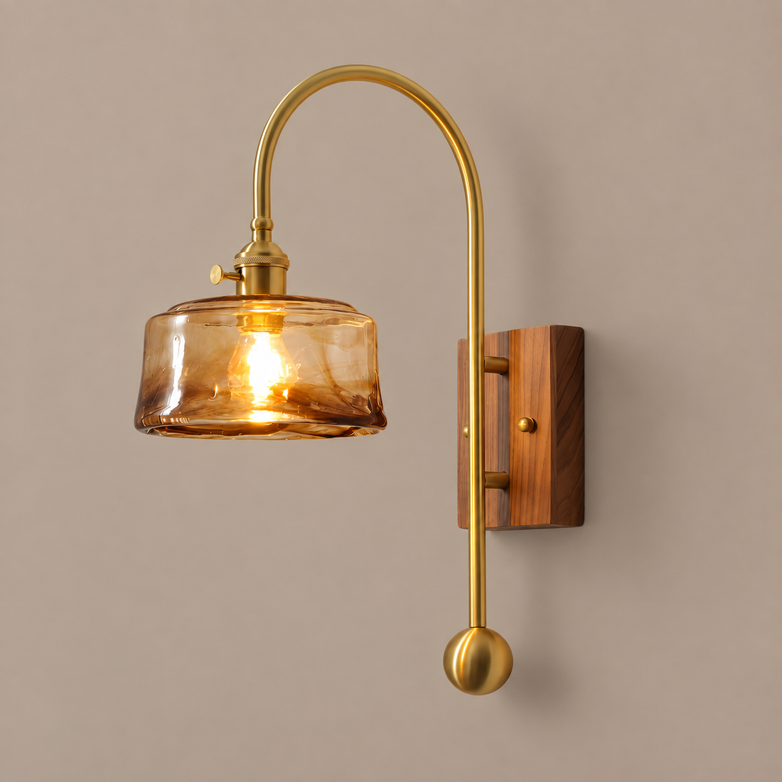 ARLETTE amber round glass wall sconce with brass arch and walnut backplate on mushroom taupe