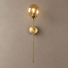 BEACON brass wall sconce with amber glass globe and long stem on mushroom taupe plaster