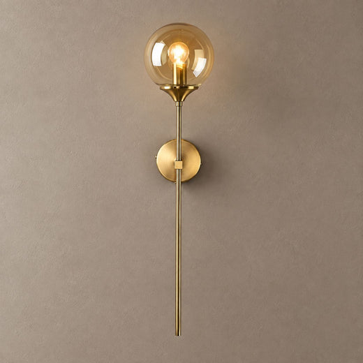 BEACON brass wall sconce with amber glass globe and long stem on mushroom taupe plaster