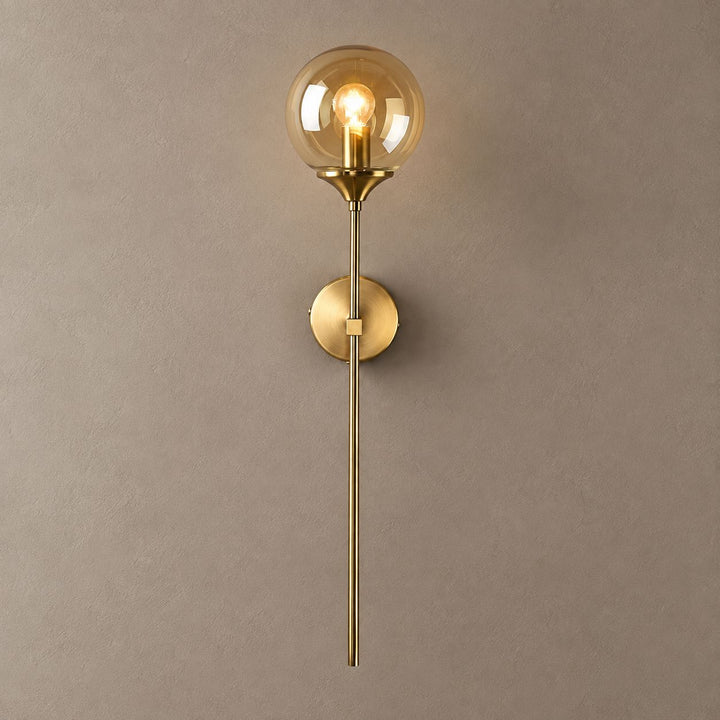 BEACON brass wall sconce with amber glass globe and long stem on mushroom taupe plaster