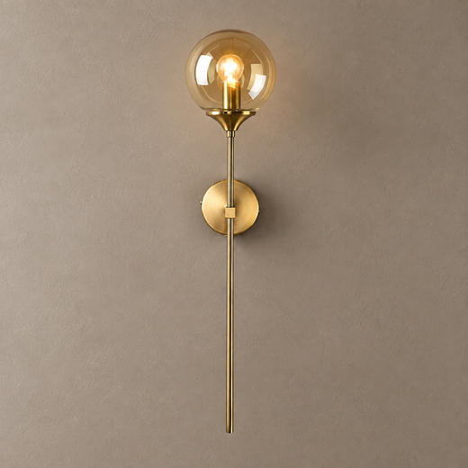 BEACON brass wall sconce with amber glass globe and long stem on mushroom taupe plaster