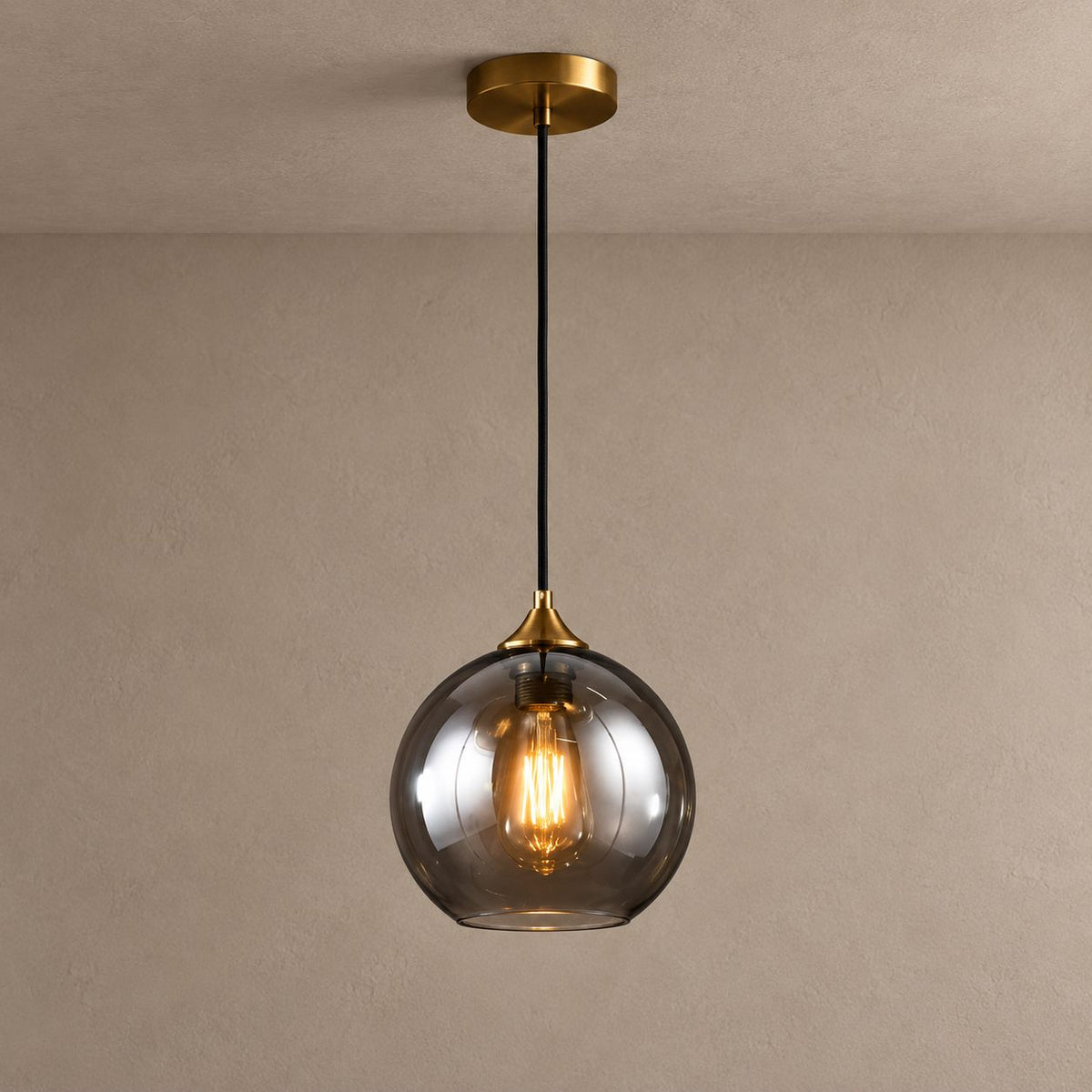 BETHANIE smoky glass globe pendant with brass canopy and warm filament bulb on mushroom taupe plaster