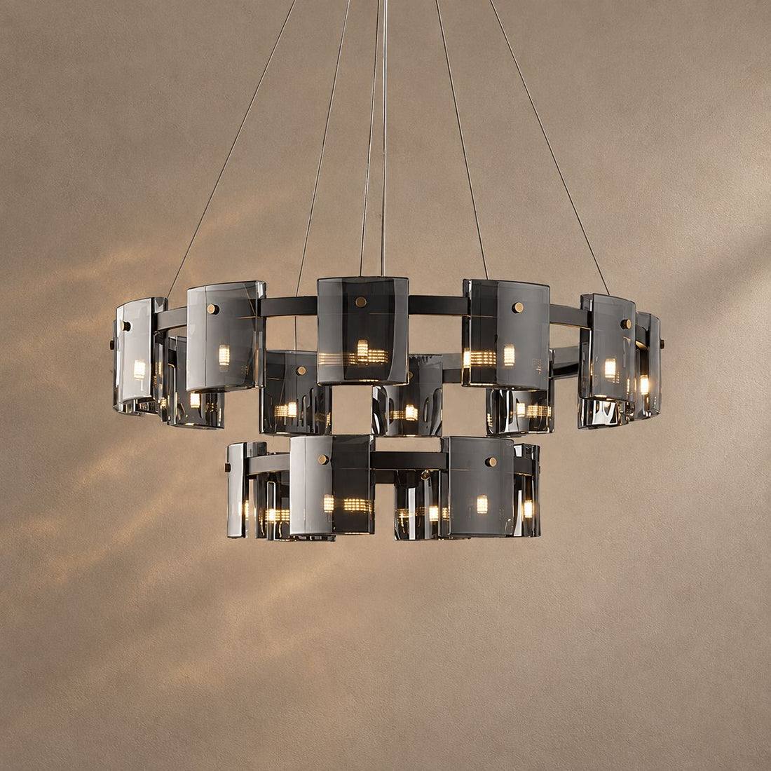 CALYX lighting on a mushroom taupe background with natural shadows
