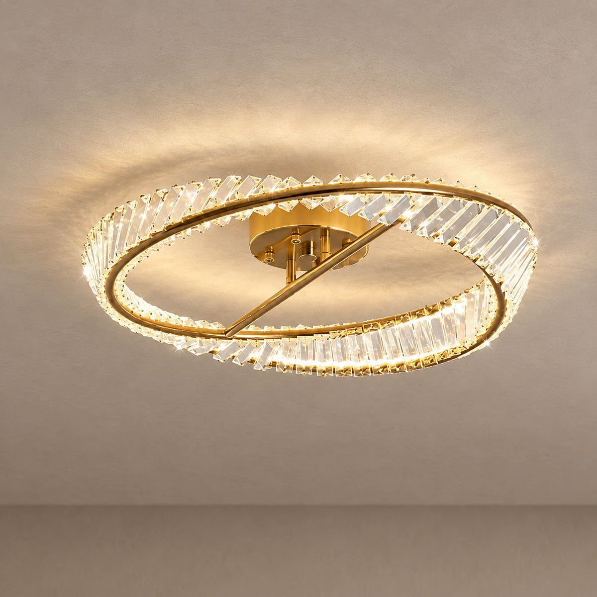 CHARIS ceiling light with a gold ring and clear faceted crystals mounted on mushroom taupe plaster