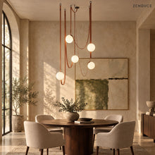 CORIA five-light Red leather and opal glass chandelier over a round walnut dining table