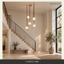 CORIA 5-light Red leather and opal glass chandelier in the shared staircase setting, showing an illustrative adjustable suspension arrangement