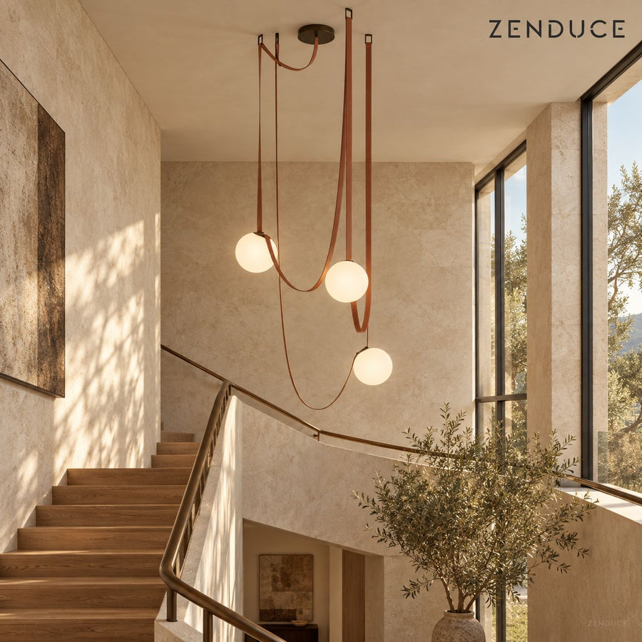 CORIA three-light chandelier with red-brown leather straps and opal glass globes in a real staircase setting