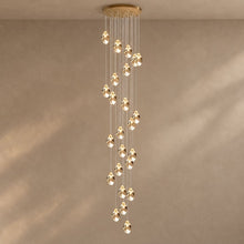 CRYSTAL ROCK (GRAND) spiral cascade of crystal pendant lights from a gold-finish canopy, lit