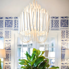 CERYNE - White wooden sticks and curved arms above a dining area