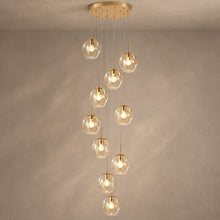 ELIOS cascading chandelier with ten champagne glass globes and gold fittings on mushroom taupe plaster
