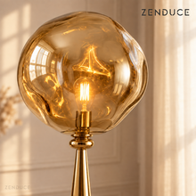 ELUNE Gold close-up showing the organically shaped reflective acrylic shade and warm LED bulb