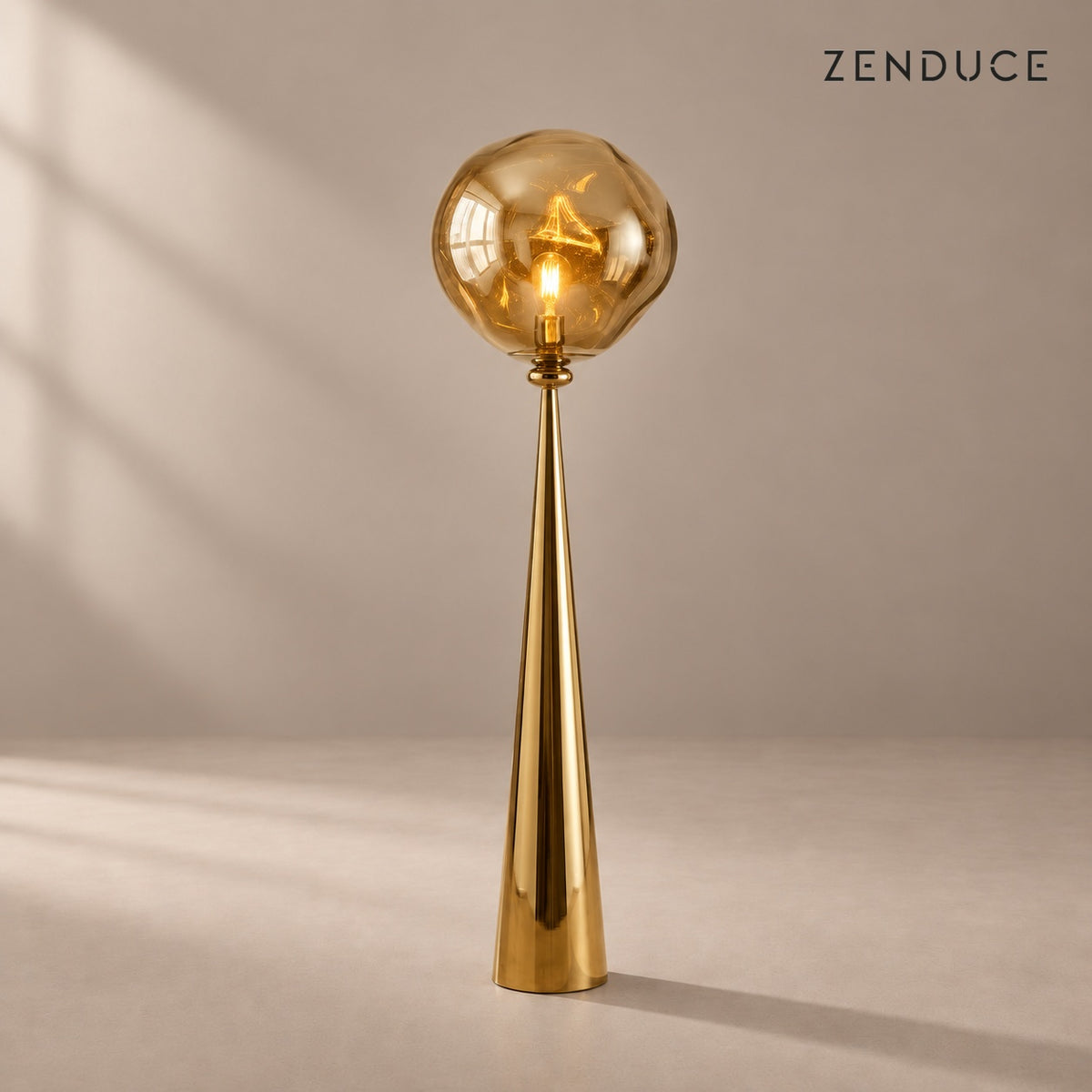 ELUNE Gold acrylic floor lamp with matching reflective conical pedestal and natural shadow