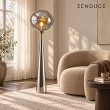 LAVA FLOOR Chrome Silver floor lamp visualized beside a boucle armchair in a bright reading nook